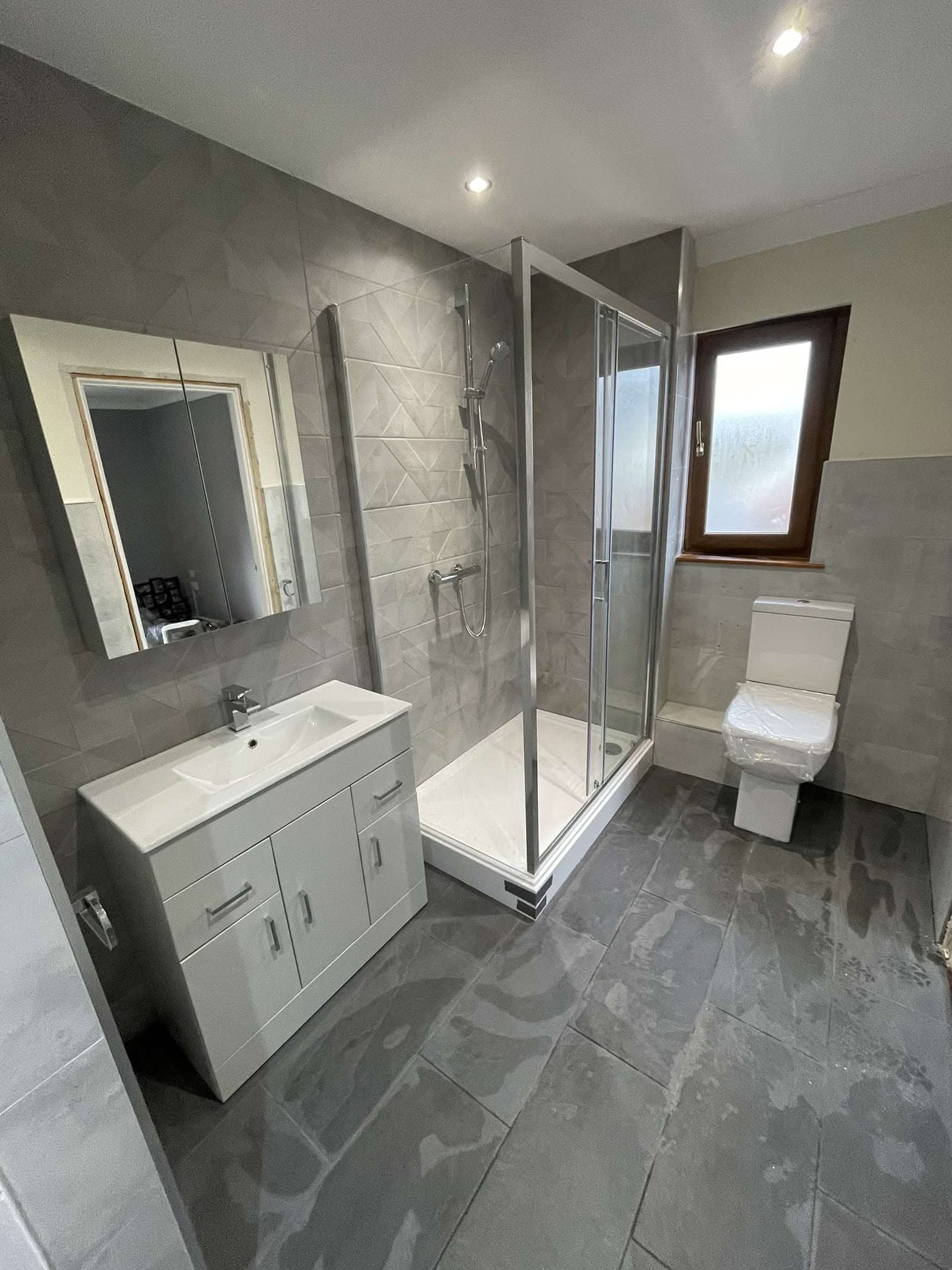 Modern bathroom with large shower enclosure and vanity unit