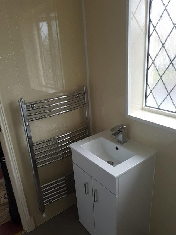 Chrome towel rail and basin vanity unit